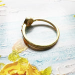 Golden ring with colorful palm tree emblem
