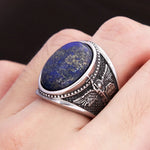 Men's ring with blue lapis lazuli and angel design in antique silver