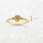 Golden ring with colorful palm tree emblem